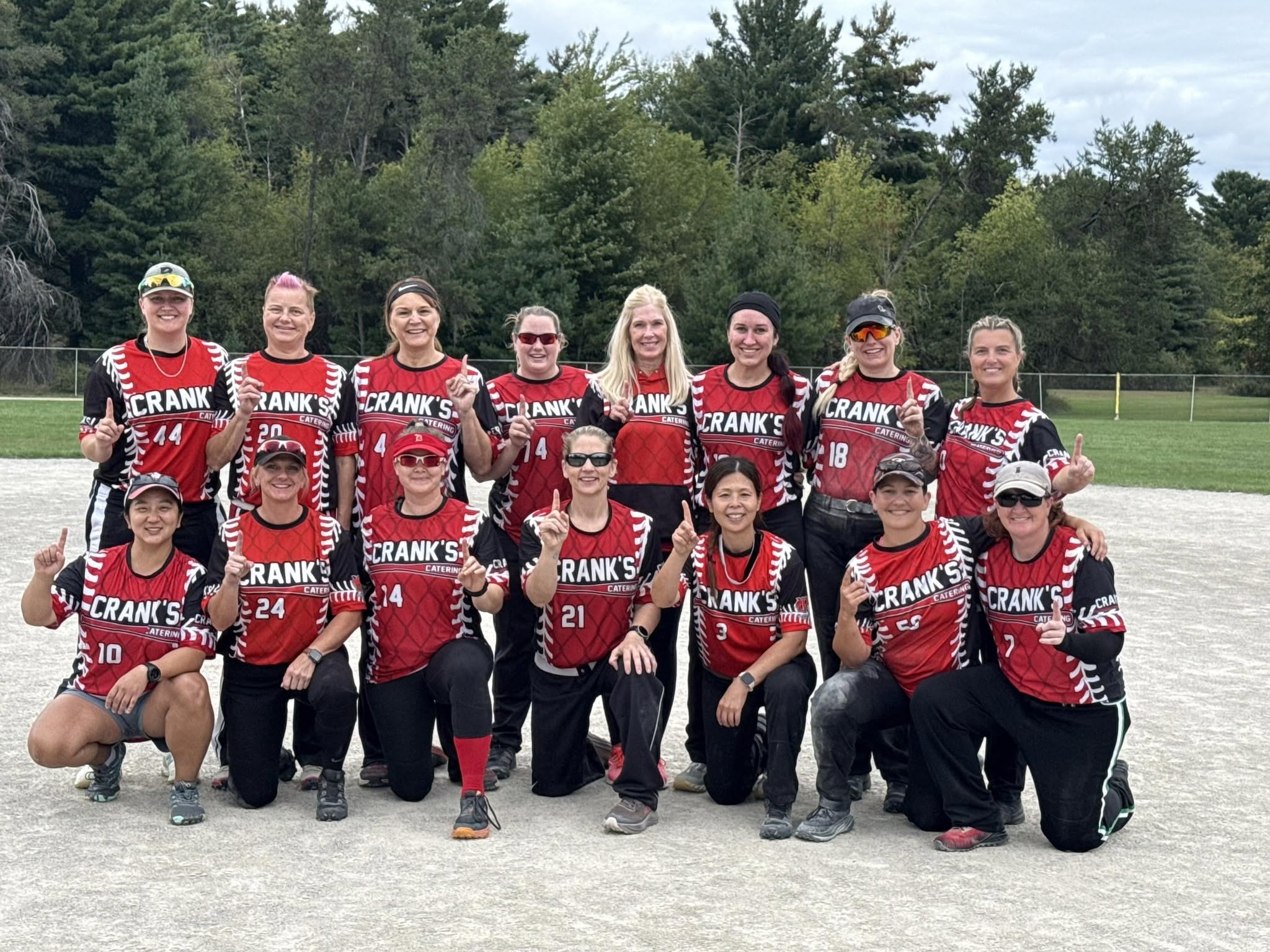 Crank's Catering, the 2026 Tawas Women's Softball Tournament champions, celebrating on the field